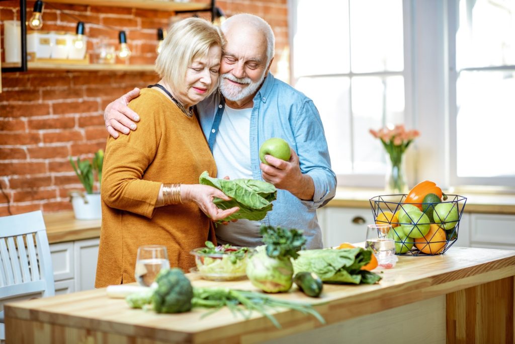 Senior couple with healthy food at home