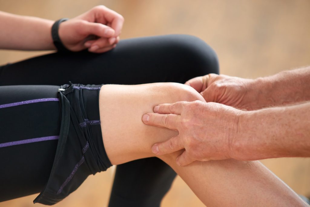 Young woman having leg injury.